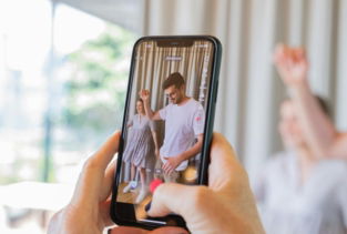a person taking a picture of a man and woman