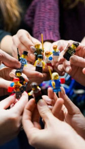 people holding miniature figures